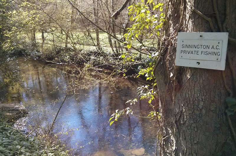 River view with angling club sign